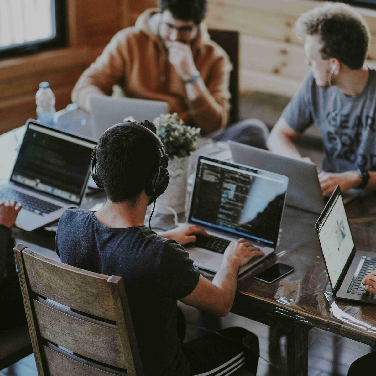 Young people sitting around a table working on their business.